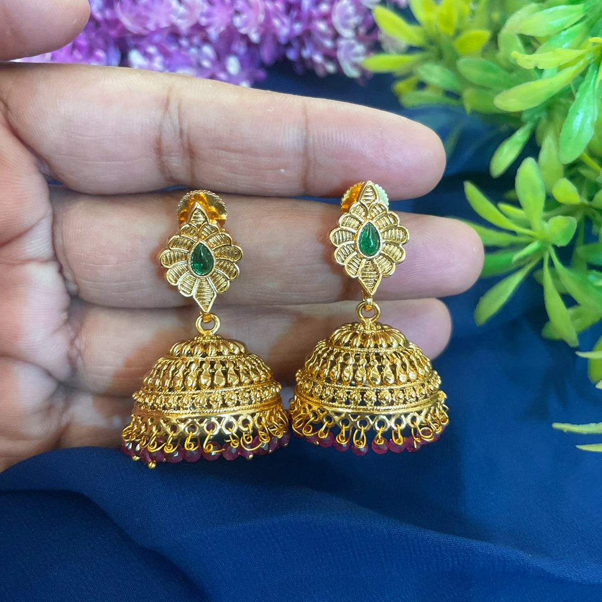 Expertly crafted and plated with gold, these Jhumki earrings are a must-have for any jewelry collection