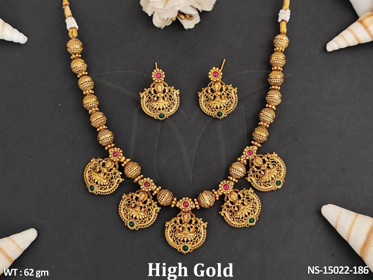 This elegant Temple Jewelry Set showcases a beautiful South Indian design with a high gold polish.